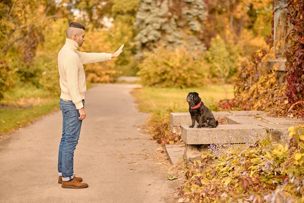 A man giving a command to his dog