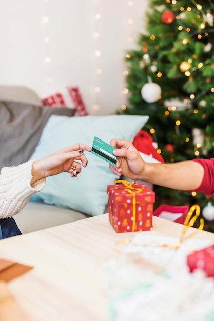 Man giving credit card to woman in white 