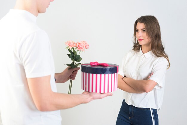 Man giving gifts to dissatisfied woman
