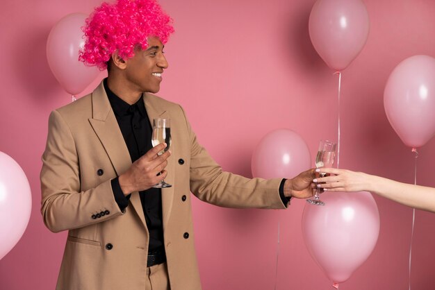 Man giving a glass of champagne to a friend