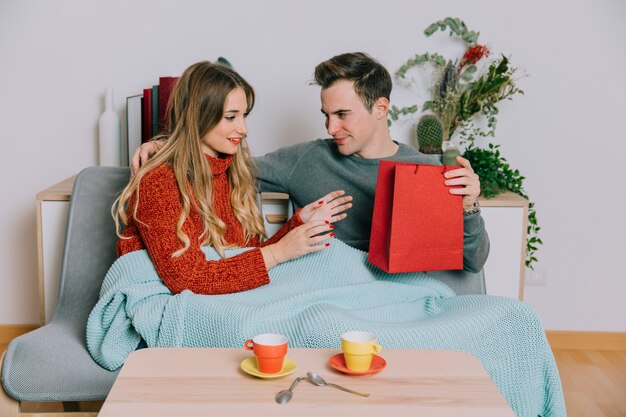 Man giving present to woman