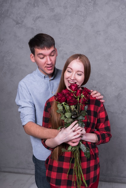 Man giving roses to young woman