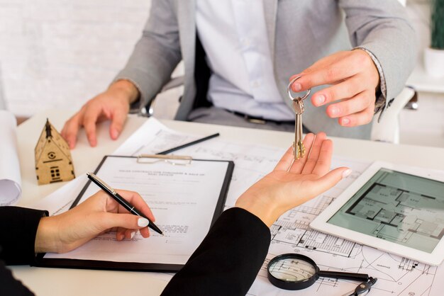 Man giving some keys to a woman