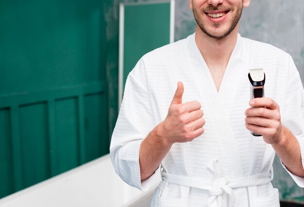 Man giving thumbs up and holding trimmer