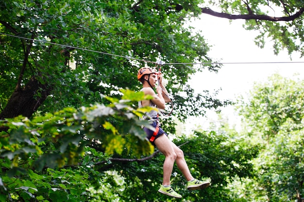 Free photo man goes down on the rope in an entertainment park