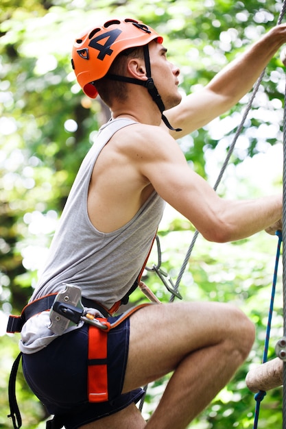 Free photo man goes down on the rope ladder