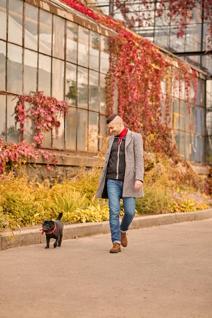 A man going for a walk with his dog