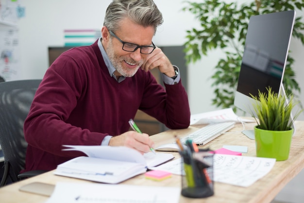 Man in good mood working at the desk