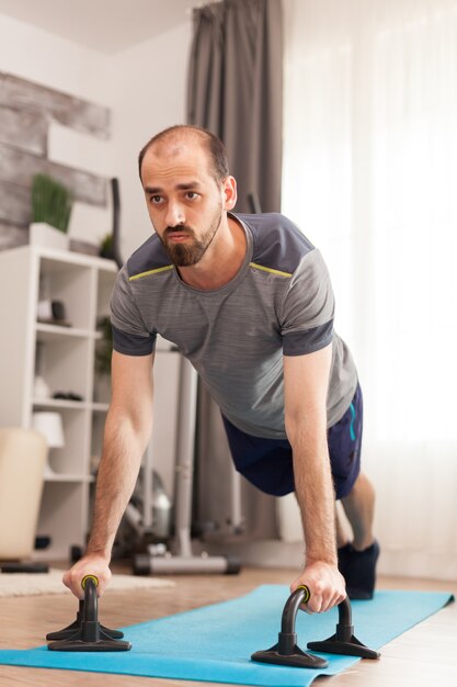 Man in good physical shape doing push ups during global pandemic.