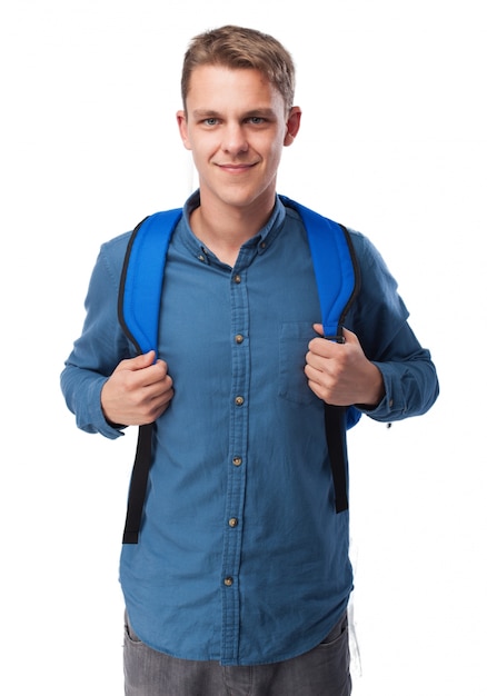 Man grabbing the grips of a blue backpack
