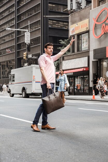 Man hailing taxi on road