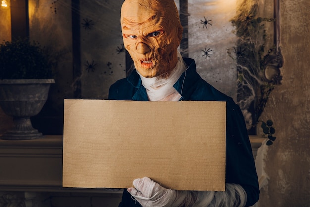 Free photo man in halloween costume posing with tablet