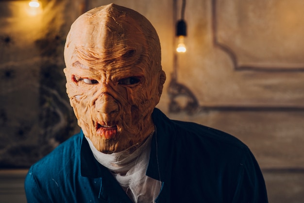 Man in Halloween mask posing in studio