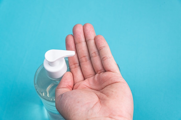 Man hand in container with alcohol gel 