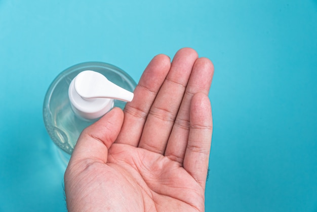 Man hand in container with alcohol gel 