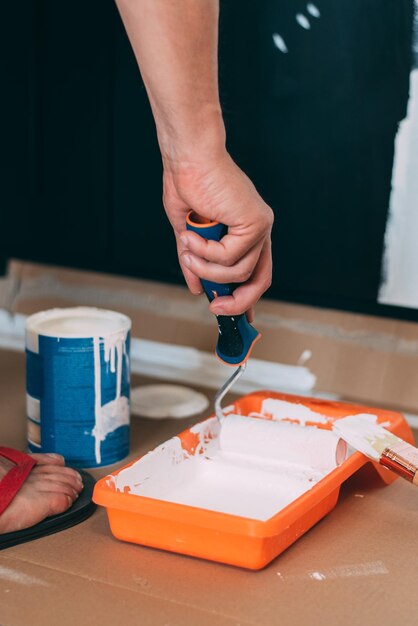 Man hands painting with a roller