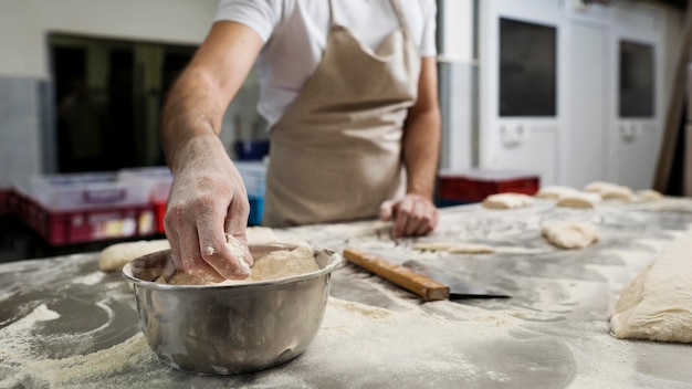 Free photo man hardworking in a bread bakery