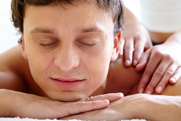 Man having body massage in spa salon