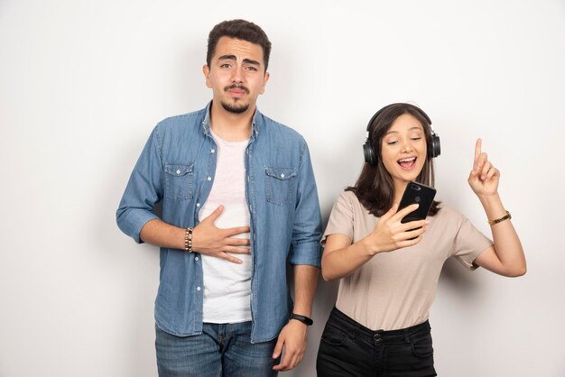 Man having breakdown while woman dancing around music.