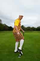 Free photo man having a game of golf outdoors on the course