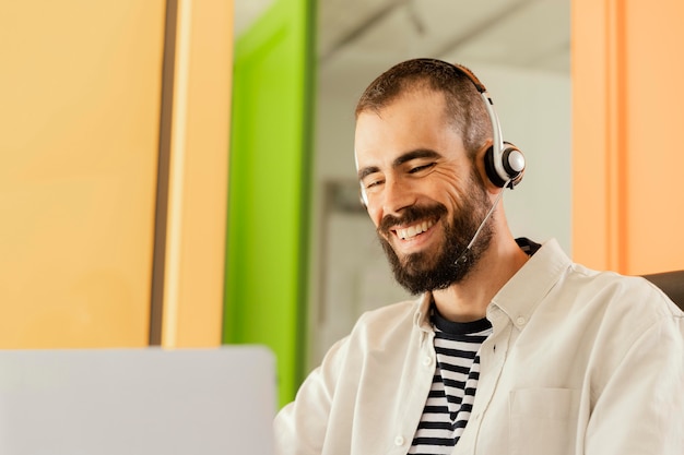 Free photo man having an online meeting for work