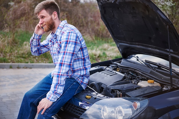 Free photo man having a problem with his car