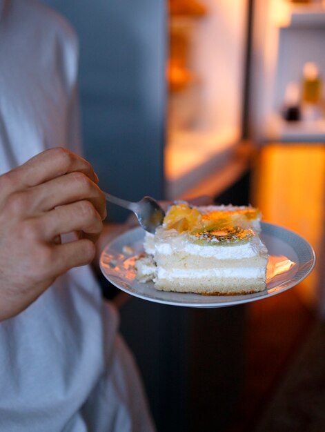 Man having snacks at night side view