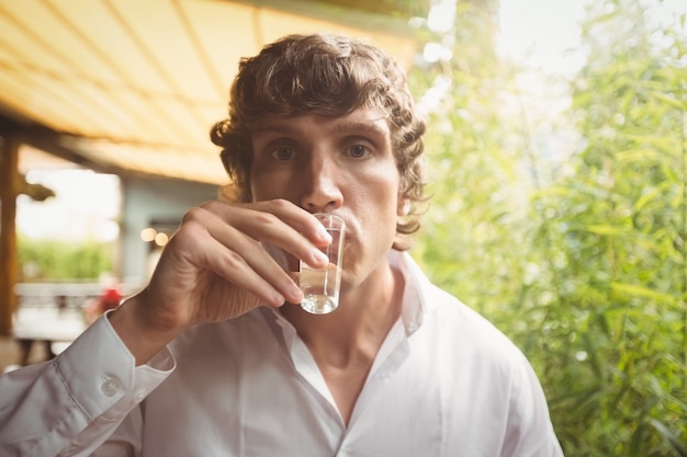 Man having tequila shot in bar