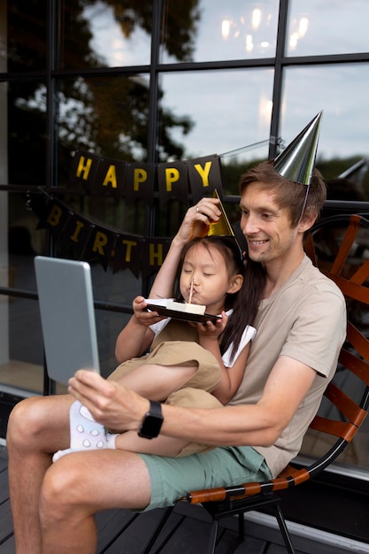 Man having a video call with his wife on their daughter's birthday