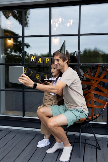 Man having a video call with his wife on their daughter's birthday