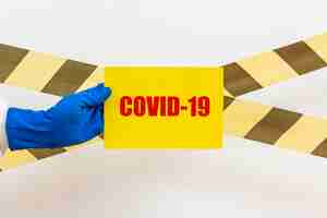 Free photo man in hazmat suit with covid-19 sign