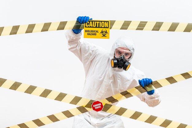 Man in hazmat suit with danger sign