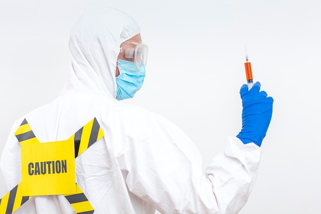 Man in hazmat suit with danger sign