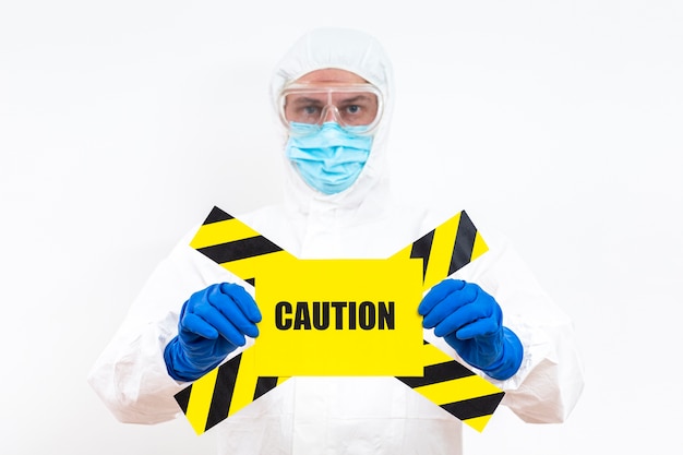 Man in hazmat suit with danger sign