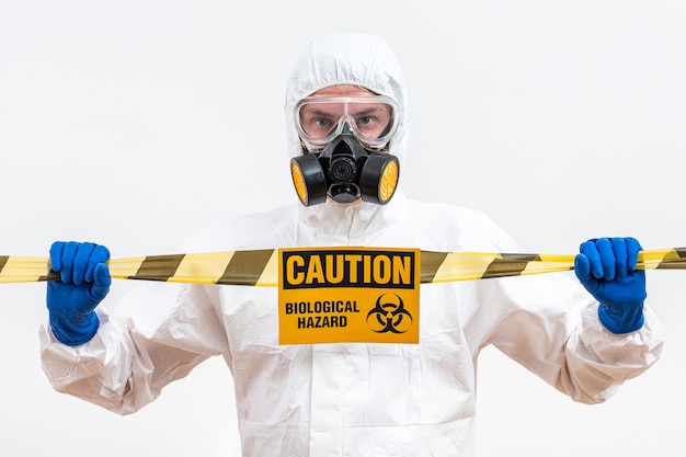 Man in hazmat suit with danger sign