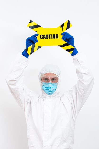 Man in hazmat suit with danger sign