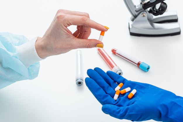 Man in hazmat suit with medicine pills