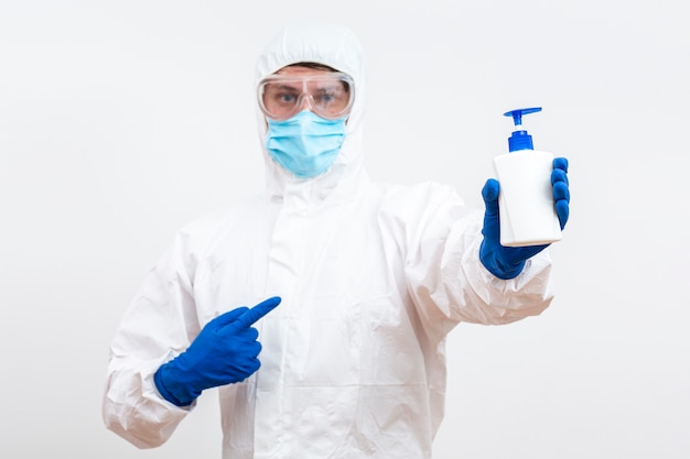 Free photo man in hazmat suit with soap bottle