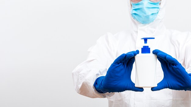 Man in hazmat suit with soap bottle