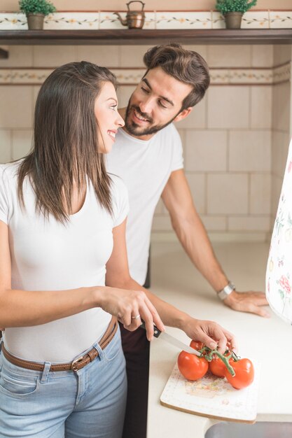 Man helping girlfriend with cooking