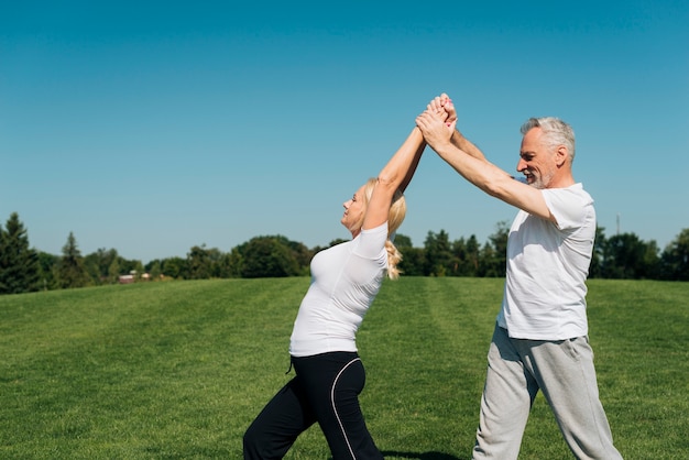 Free photo man helping woman straighten her back