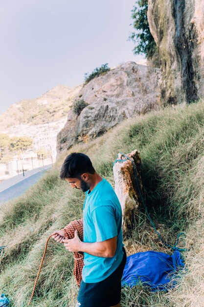 Man on hill next to road