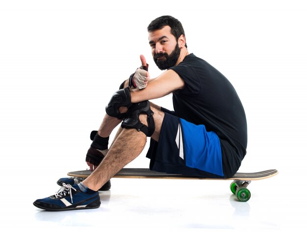 Man on his skate with thumb up