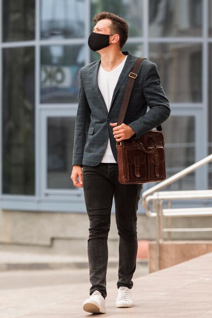 Man on his way to work during pandemic and wearing face mask