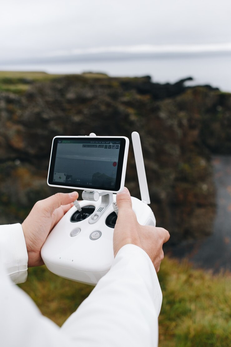 Free Photo man hold drone and remote control in iceland