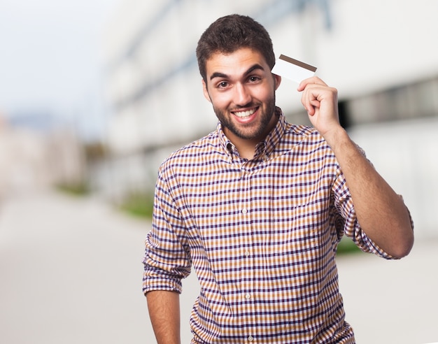 Man holding arm up showing plastic card. 