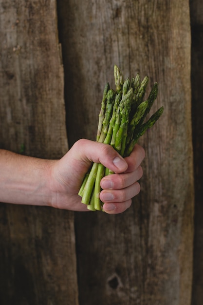 Foto gratuita man holding asparagi