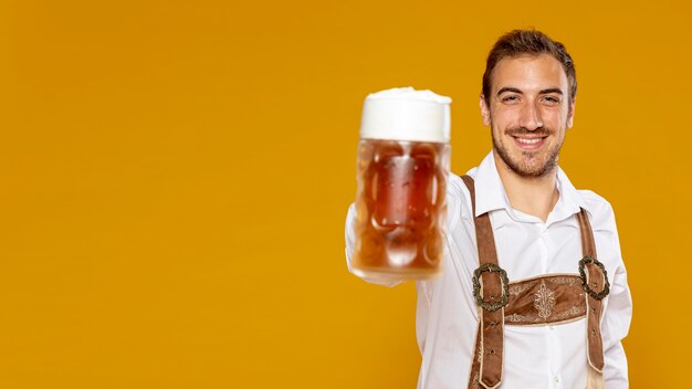 Man holding beer pint with copy space