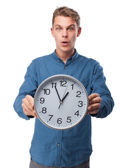 Man holding a big clock