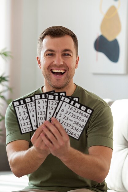 man holding bingo cards medium shot